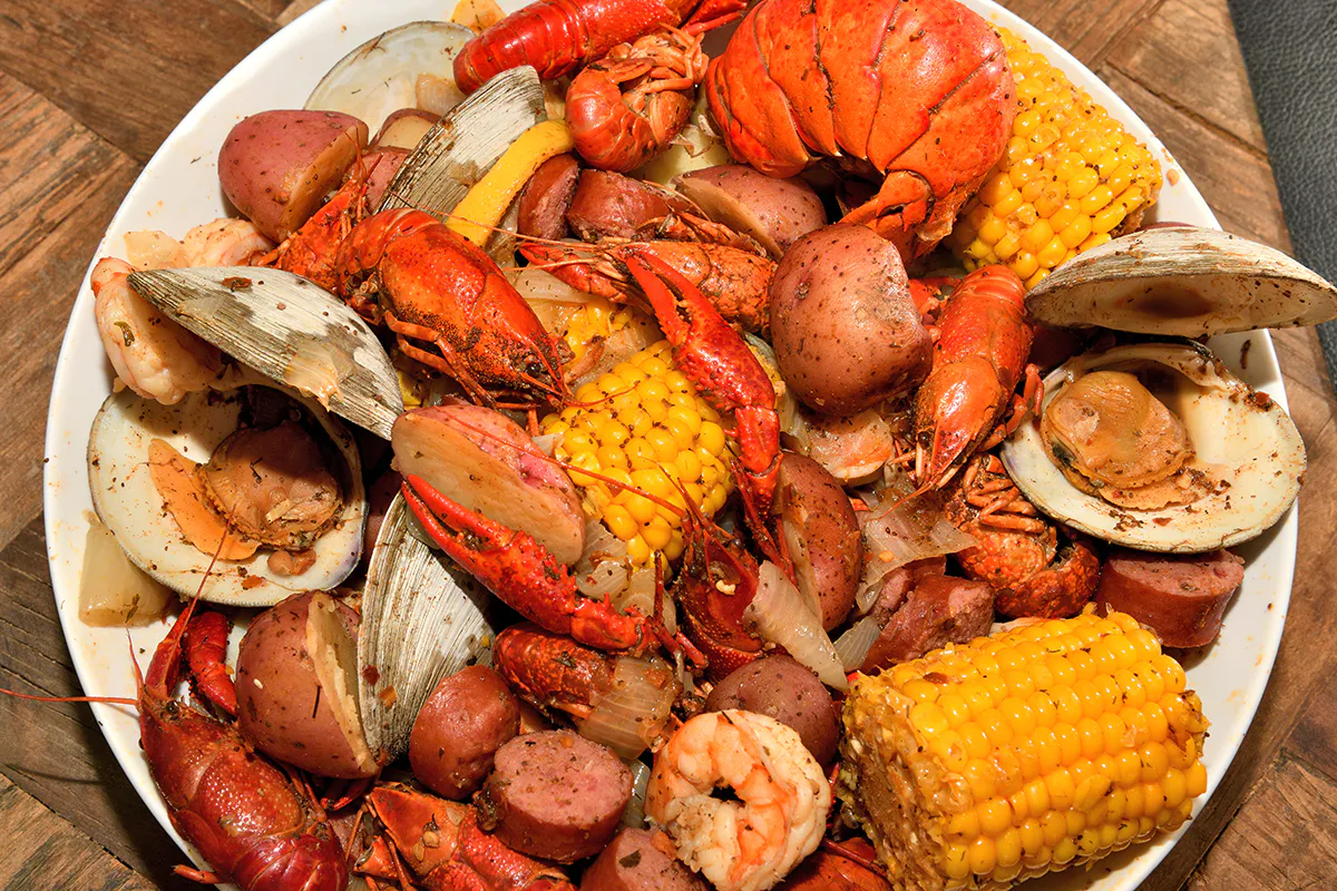 Loaded seafood boil platter with crawfish clams corn and sausages at Crab 99, a Cajun Seafood & Grill Restaurant in Phoenix